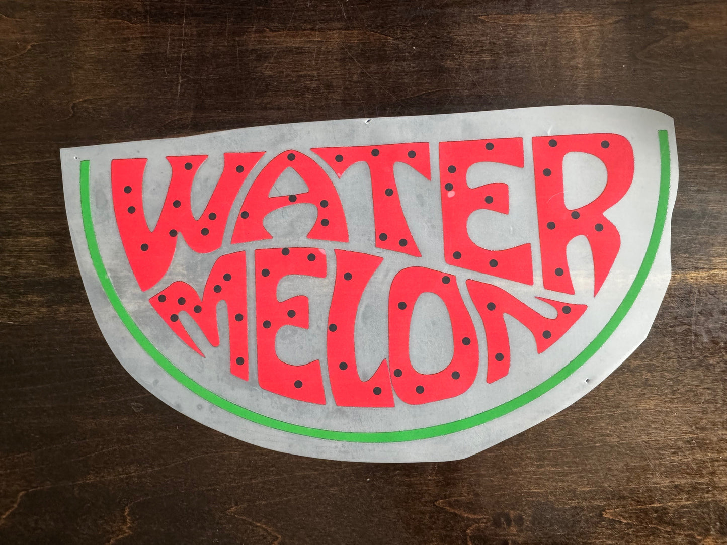 Watermelon-themed vinyl decal on a wooden surface